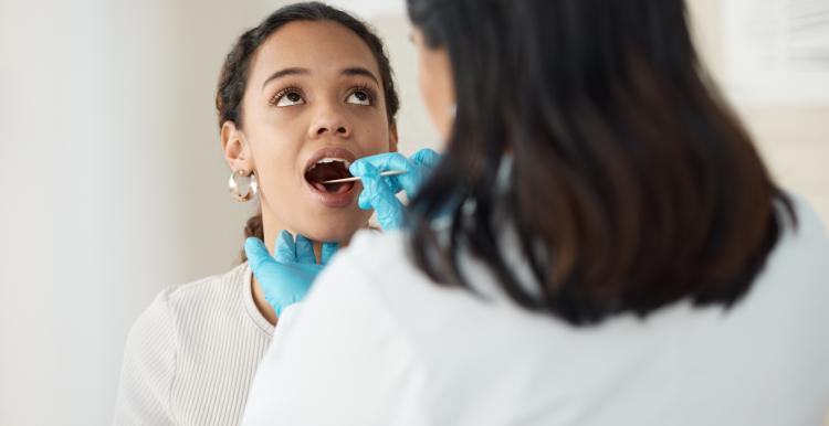 photo of a young woman have a dental examination