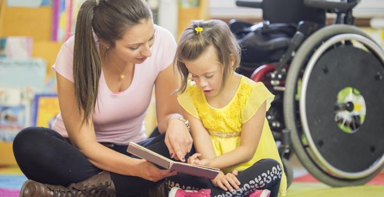 a woman with her daughter reading a book