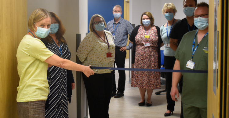 woman cutting a ribbon at new treatment centre