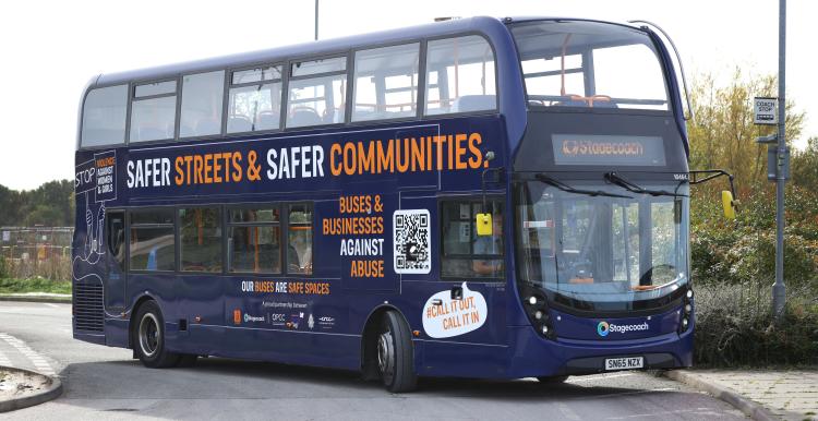 Double decker bus with 'Safer Streets and Safer Communities' campaign message written on its side