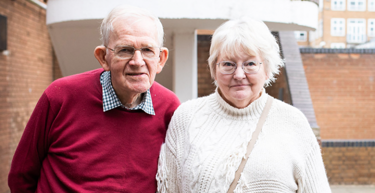 Picture shows older mana nd woman standign looking at the camera at a Healthwatch event