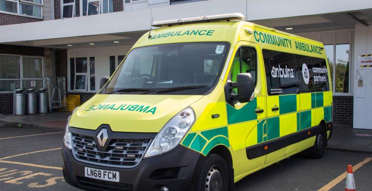 An ambulance parked outside a hospital unit.