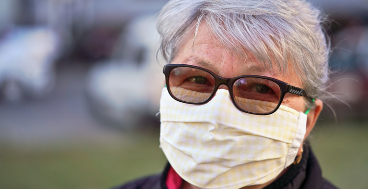 woman wearing a mask looking at camera