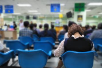 People sitting in the waiting area of a medical centre. 