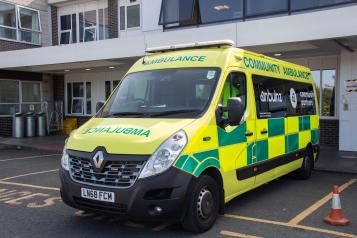 An ambulance parked outside a hospital unit.