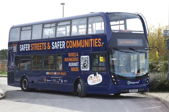 Double decker bus with 'Safer Streets and Safer Communities' campaign message written on its side