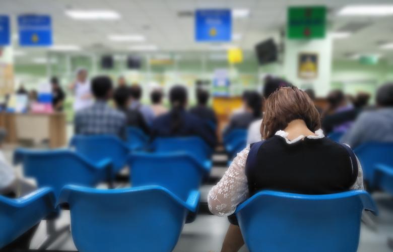 People sitting in the waiting area of a medical centre. 